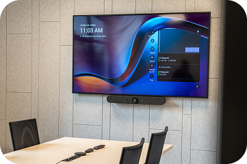 Small meeting room with a Logitech video bar and a wall display
