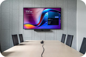 Small meeting room with a Logitech video bar below the display
