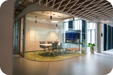 Glass-walled medium meeting room with a display in an open space